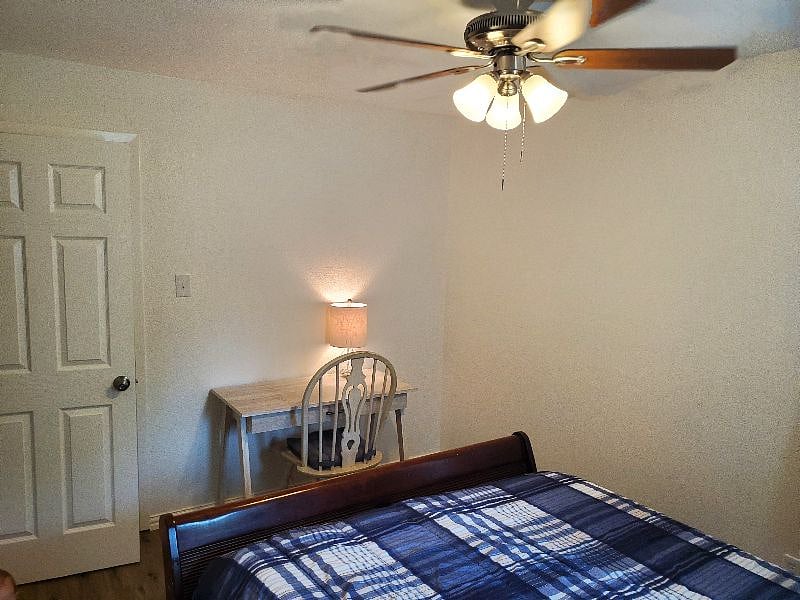 Bedroom one features a queen bed and a designated workspace