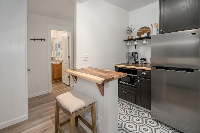 Discover the adorable kitchenette, complete with a Keurig coffee maker, mid-size refrigerator, and microwave for your convenience. 