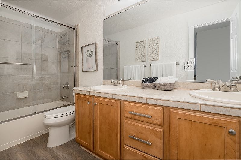 Indulge in luxury in the full private bathroom featuring two sinks, ample storage, and a relaxing soaking tub. 