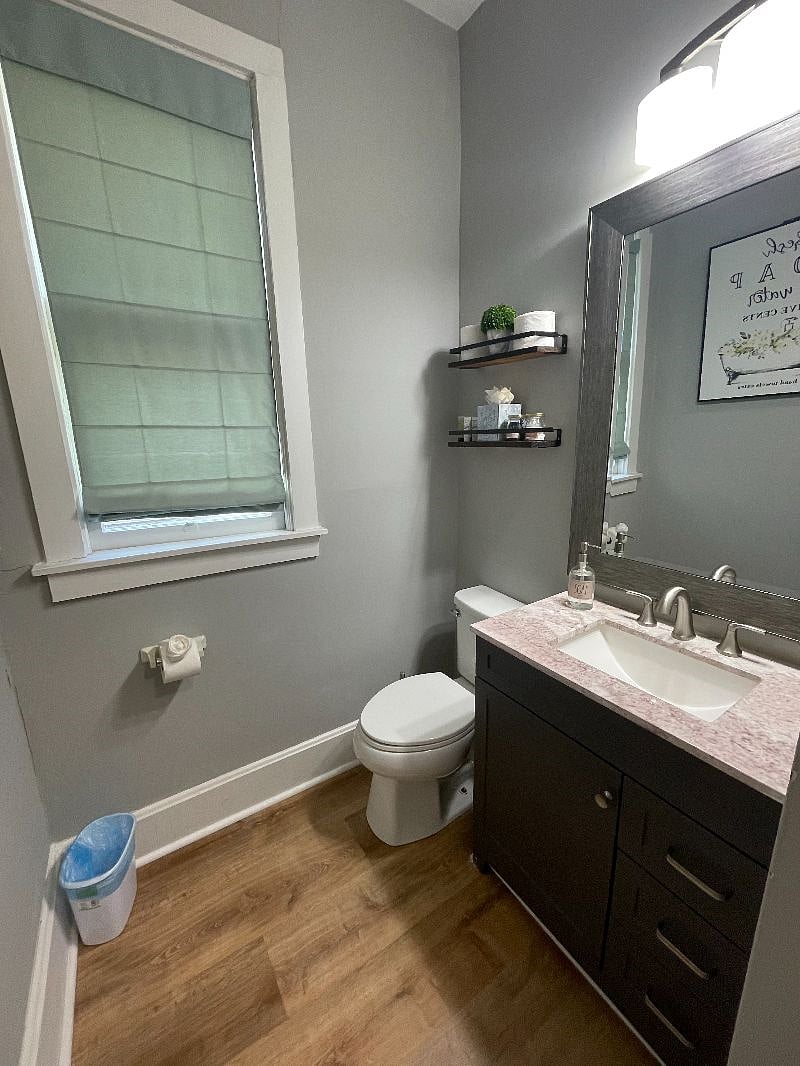 The bathroom has new flooring, a tub/shower combo, and new vanity with storage