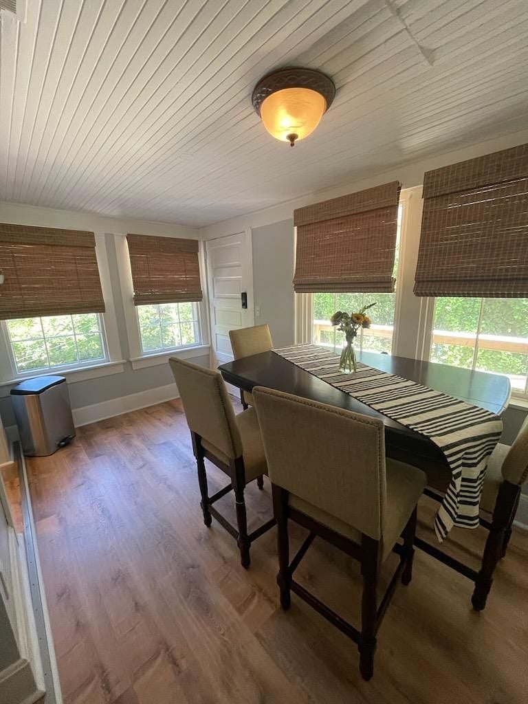 New flooring and a spacious pub-style table complete the dining area. Off of the dining area, you'll find a private deck for morning coffee or enjoying the outdoors.