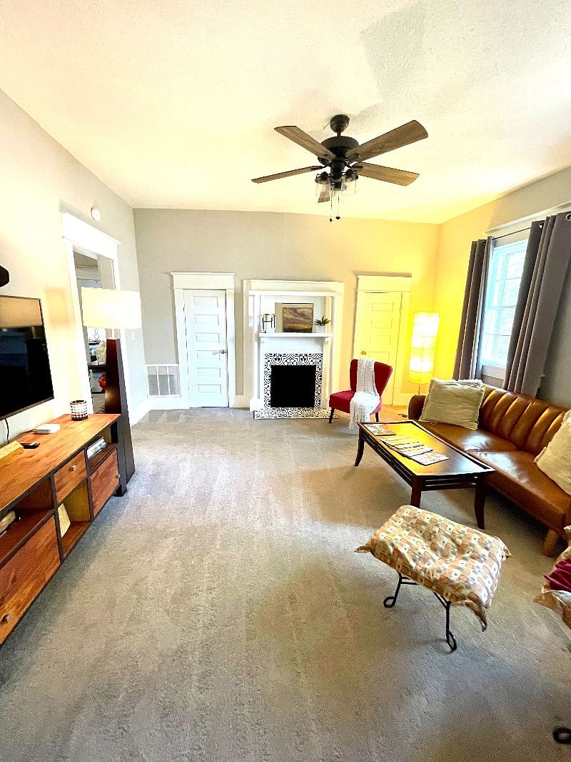Large den with multiple seating options, smart TV, lots of natural light