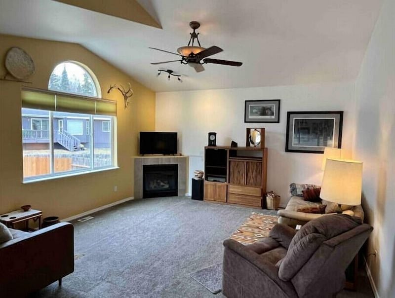 Living room with vaulted ceiling, gas fireplace and leather furniture