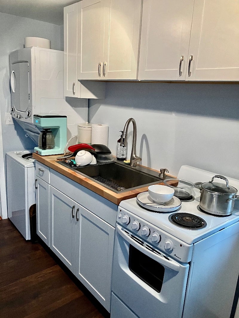 Cute little galley kitchen with stacked washer and dryer