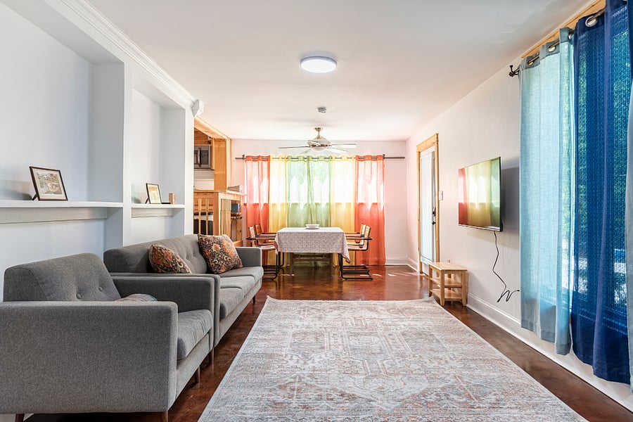 Lower level living room with Private entrance and steps leading to the kitchen and bathroom