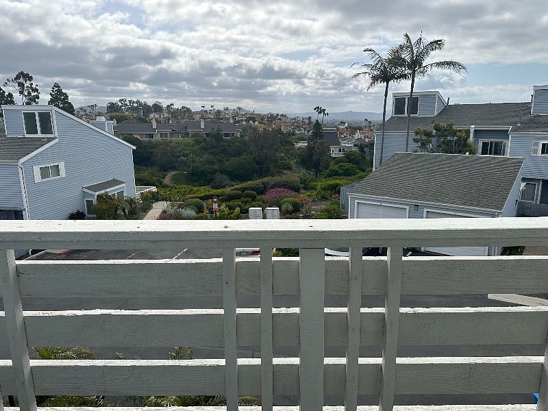 View of city and mountains outside living room balcony
