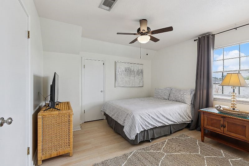 2nd upstairs bedroom with walk in closet, television and black out curtains.