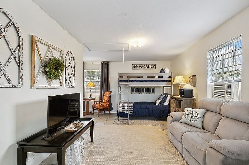 Extra bonus room with twin Bunkbeds, game table, games, tv and reclining loveseat.
