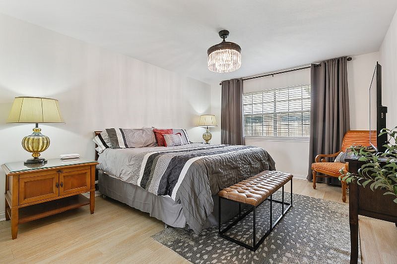 Master bedroom with luxurious king bed. Curtains are blackout for a great nights sleep.
Nightstands with pull out writing area and large television.