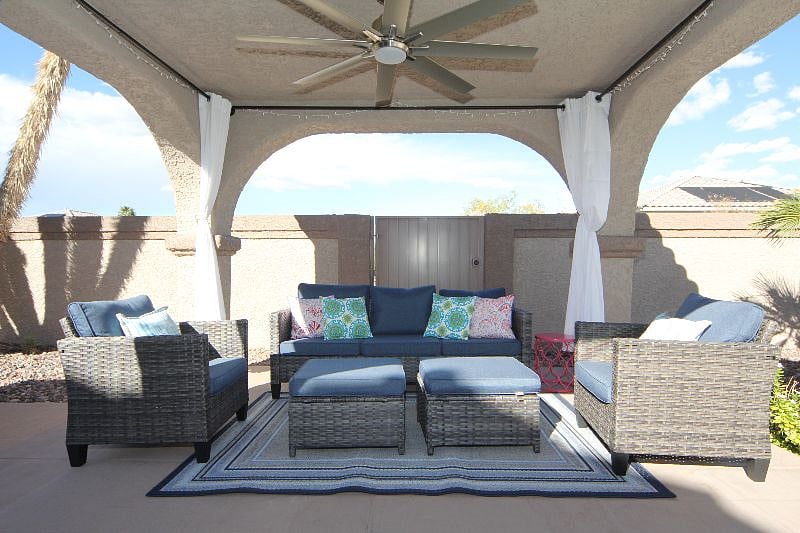 Gazebo relaxation space. Ceiling fan, shade curtains