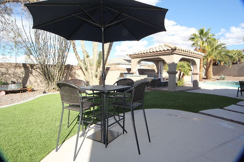 8 person outdoor high top dining table. Also additional 8 person regular table dining area w/cushions