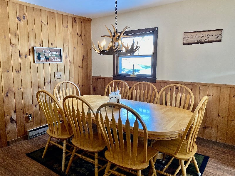 Large dinning room table also doubles a laptop/home office workspace.