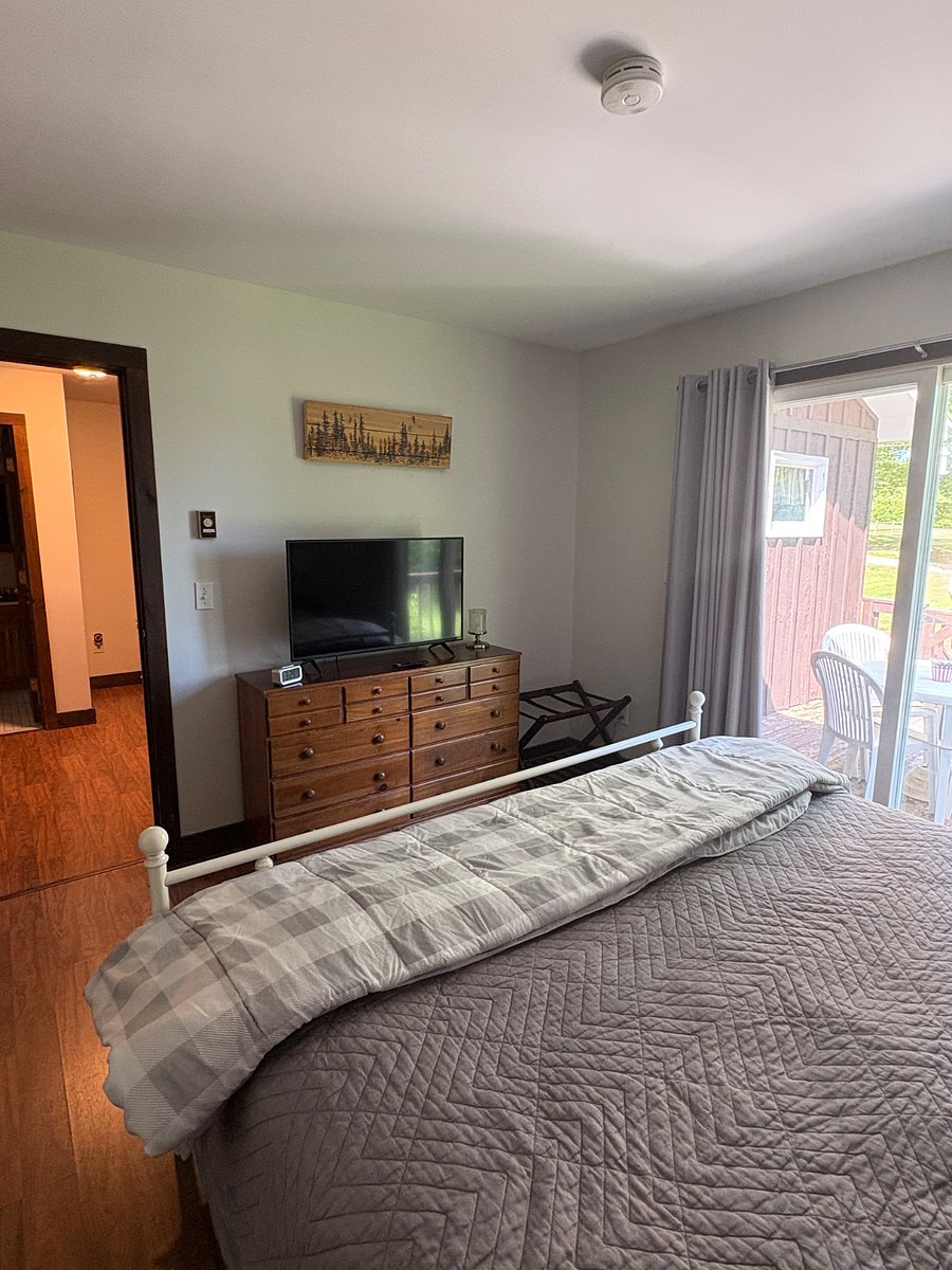 Primary bedroom smart tv, dresser, large closet and black out curtains.