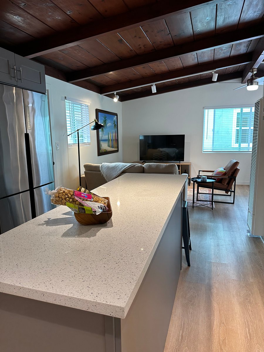 Kitchen and great room are open concept and easy to see from cooking area. Also original wood ceiling has been restored in its original feel.