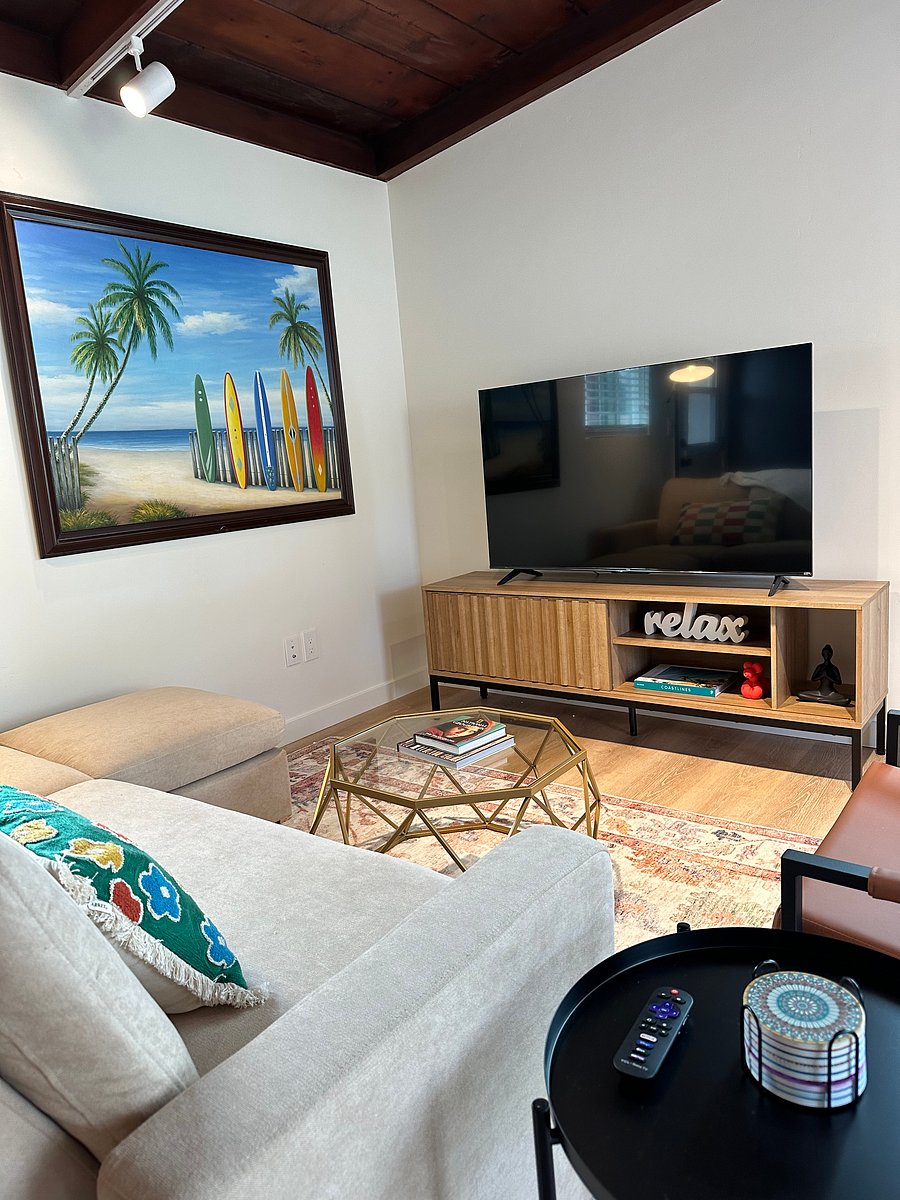 Living room has warm wood ceiling, big screen TV and a great beachy cozy vibe.