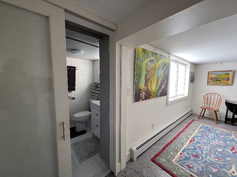 A sliding door separates the bathroom.