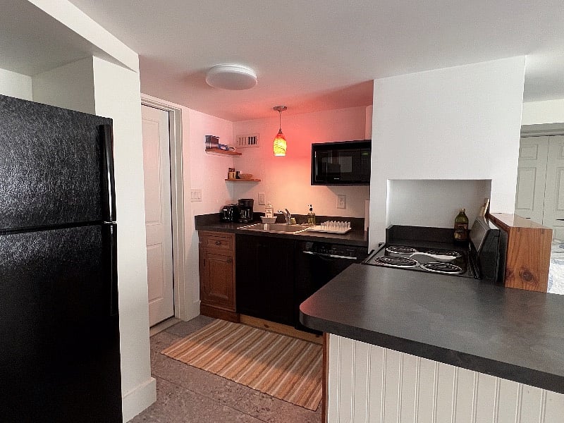 Kitchen has full-size refrigerator. Stand-alone stove includes an oven. Microwve too.