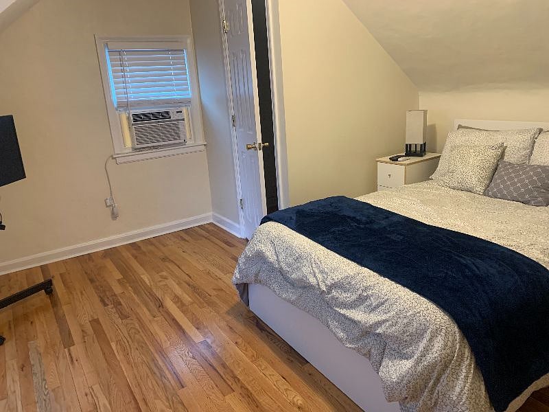 Bedroom with full size bed and 1/2 bath upstairs