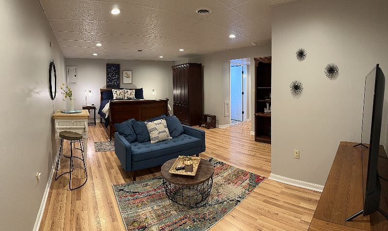 SHOWS HOW LARGE THE ROOM IS ALONG WITH ALL OF ITS ACCESSORIES IN IT!