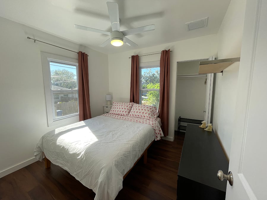 Southside bedroom with queen bed, rollaway storage under bed
