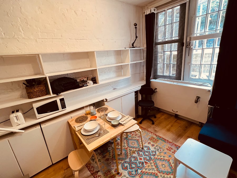 Fold out dining table with wheels. Very versatile, many tenants also use it as their desk.
