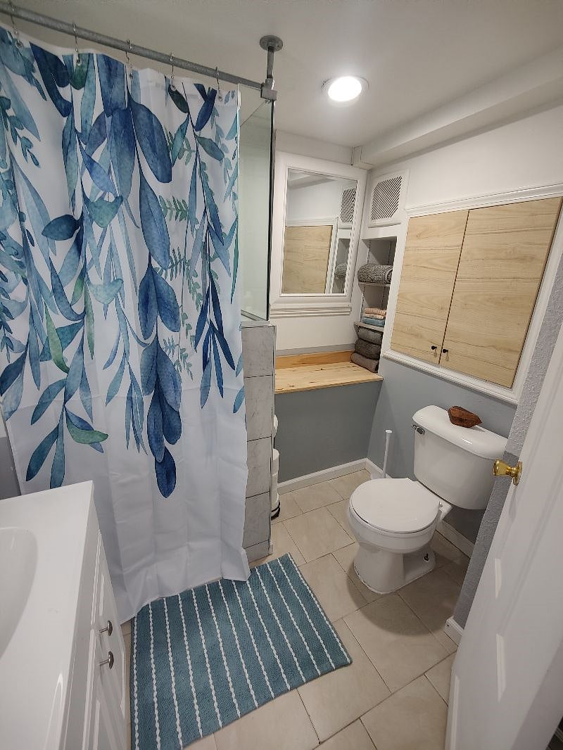 Even more storage and a second mirror in the back of the bathroom.