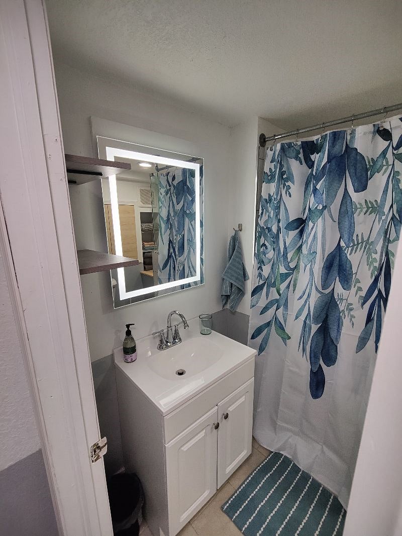Fogless mirror and plenty of shelving in the bathroom. 