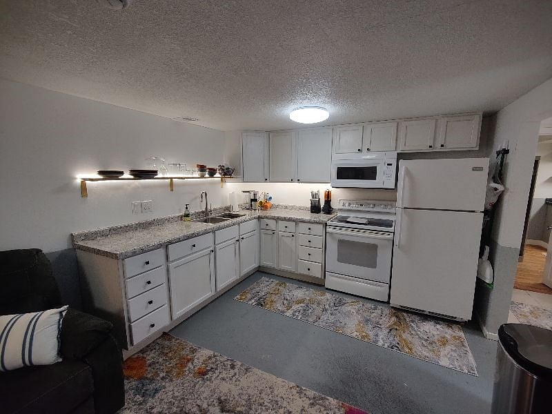 Full kitchen with included dishes and cookware. 