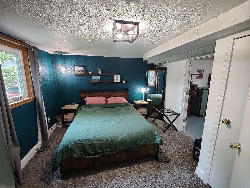 Queen sized Purple Mattress with 4 sets of bedding provided. Blackout curtains on the window. Easy access outlets for charging hardwired to the bedside stand. 