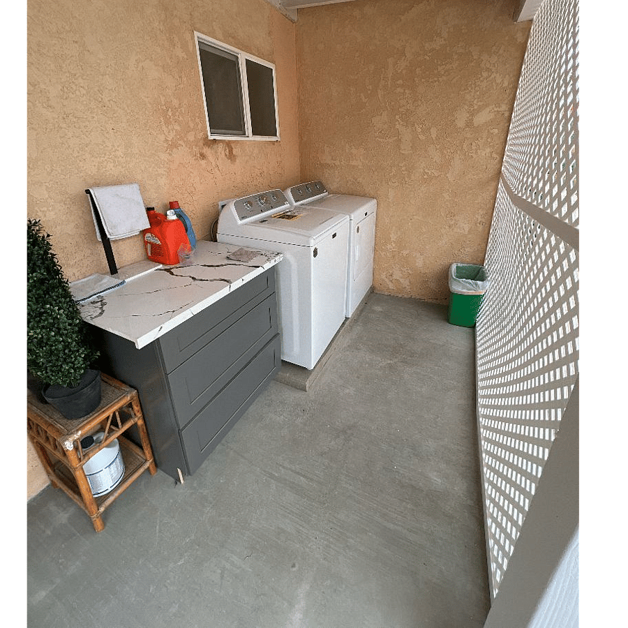 Your Washer and dryer behind a fenced area in front of the home. 