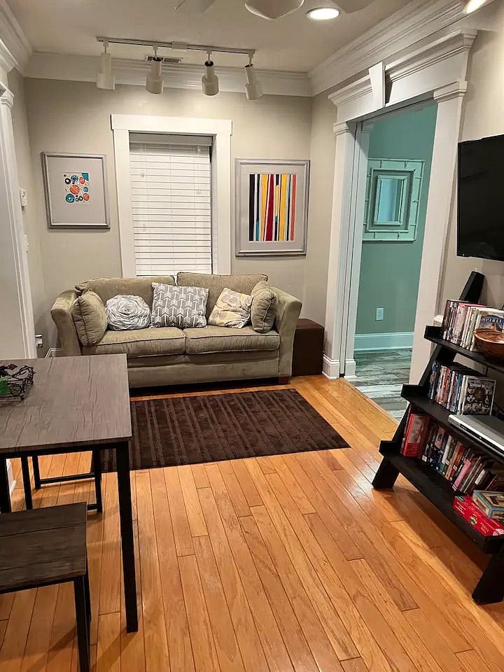 Living room/sitting area- includes couch, Smart TV, small kitchen table and information packet for the Charleston area.