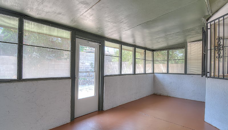 Semi-enclosed back porch. Not pictured: available seating