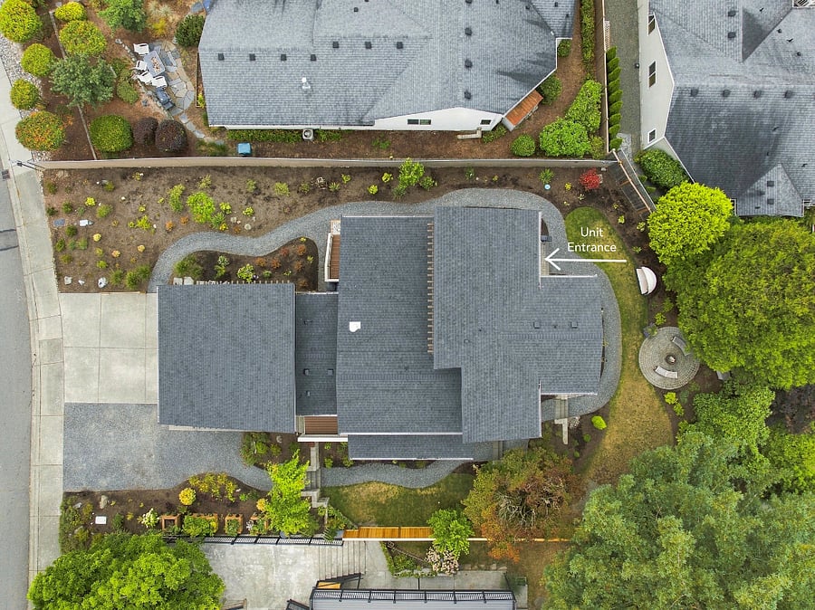 Aerial of entire home. Arrow depicts lower apartment entrance