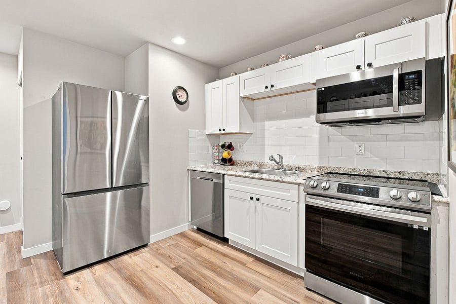 Kitchen with full size stainless steel fridge, ice maker, microwave, oven with airfry, stainless steel dishwasher