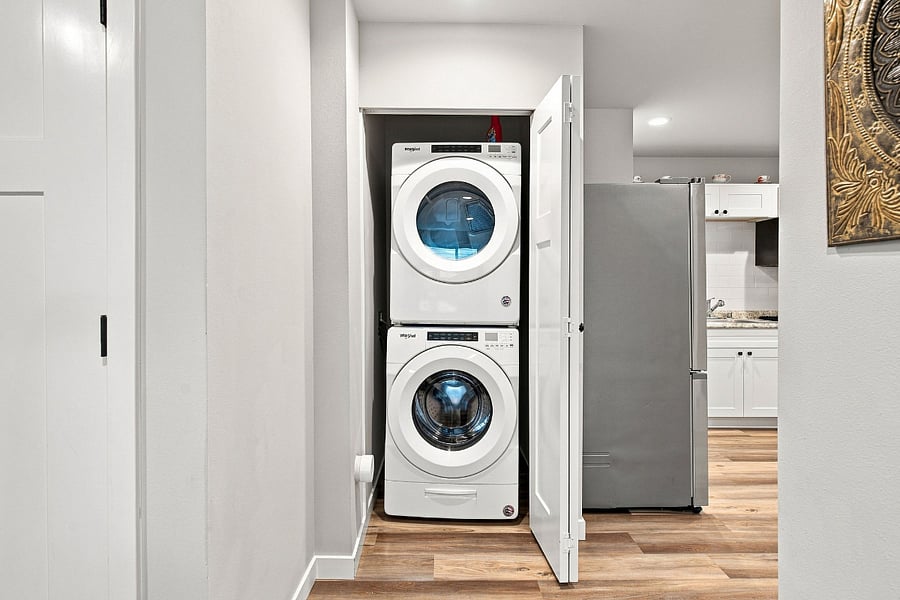 Full size stackable washer and dryer behind closet door