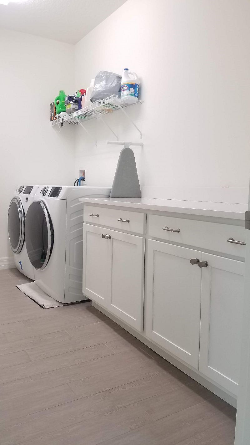 Laundry Room with large counter space and storage for laundry supplies 