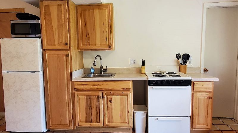Fully equipped kitchen -- plates, bowls, glasses, silverware, utensils, pots/pans, baking dishes, mixing bowls, and more...
Appliances -- toaster oven, microwave, electric grill, coffee maker, electric tea pot, fan, HEPA air filter, and more...