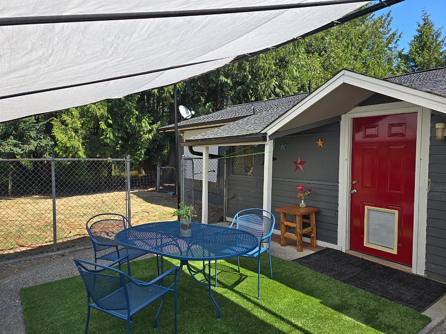 Fully fenced with cedar wood privacy fence. Picnic table w/ a heavy duty tarp for shade. You also have a huge yard to sunbathe or have a snowball fight. See rest of backyard photos.