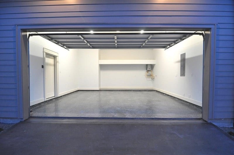 Oversized Garage with storage space and epoxy floors.