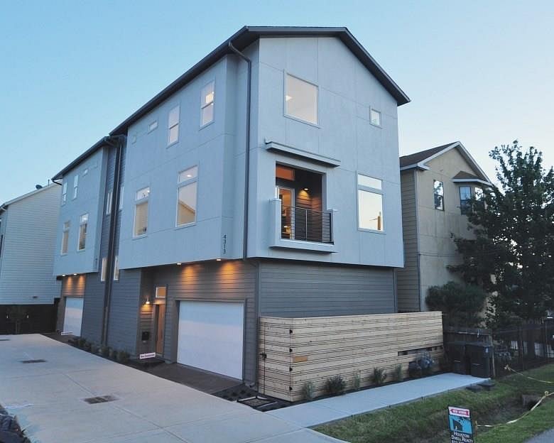 Contemporary home exterior and minimalistic landscape and fence