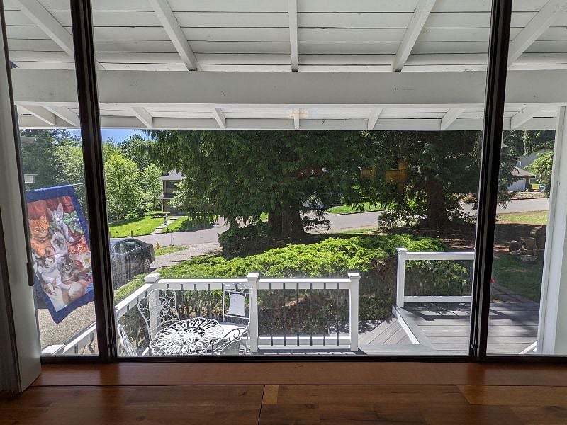 A view of the deck and neighborhood, along with shady trees for the summer.