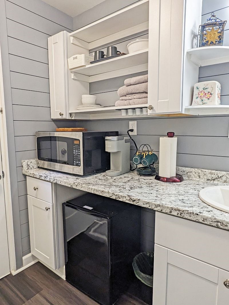 Your kitchenette, with a microwave, a KEURIG coffee machine, a toaster, a mini-fridge, an induction cooker, and kitchenware. varieties of  KEURIG coffee, and tea offered.
