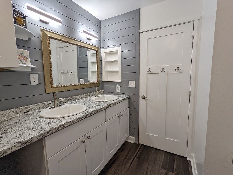 Your bathroom, with a walk-in shower room, two sinks and a cabinet.