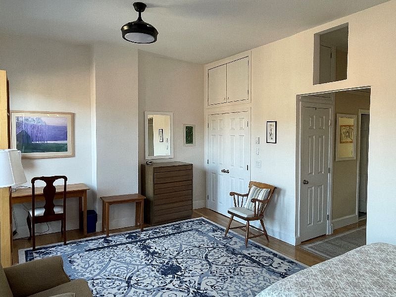 Large sitting area, desk, and ample closet space