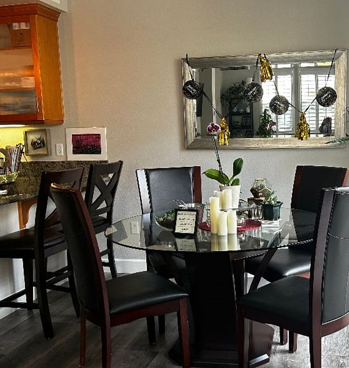 Living room with table and chairs, plus stools at the counter