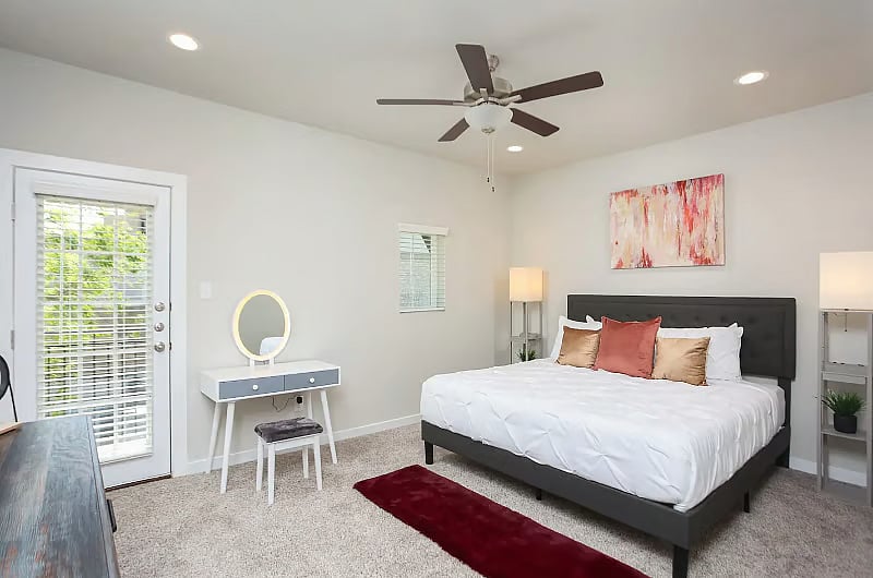 Charlie-3 BR Suite: King-sized bed with USB charging at bedside, Smart TV, vanity, walk-in closet, full bath and private balcony.