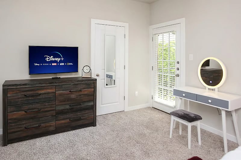 Charlie-3 BR Suite: King-sized bed with USB charging at bedside, Smart TV, vanity, walk-in closet, full bath and private balcony.