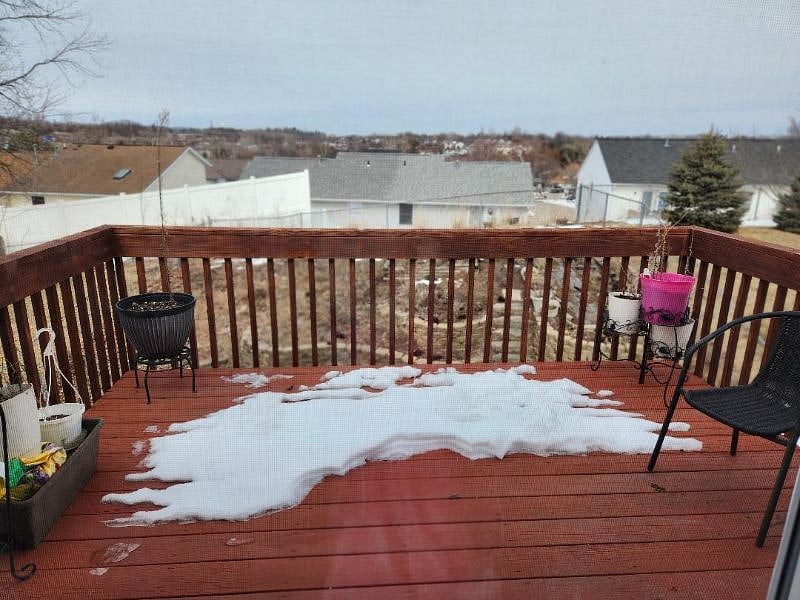 Upper level deck overlooking garden and fenced yard,