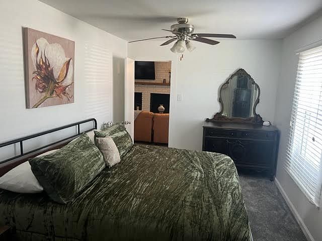 A king size bed, closet, vintage dresser with a mirror, and a chest of drawers.