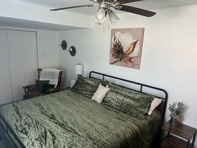 This bedroom also has a television and a rocker-recliner.